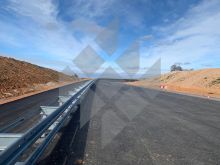 View of a test track, surrounded by a barren landscape, of the test centre in Spain with crash barriers made by Meiser Straßenbau.